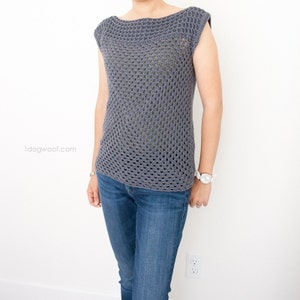 May include: A gray crochet top with a loose, open-weave pattern and a boat neckline. The top has short, capped sleeves.