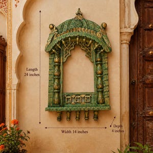 May include: A green and gold decorative wall frame with an arched top and carved details, featuring the text 95artisanlegacy. It measures 24 inches in length, 14 inches in width, and 4 inches in depth, with five small hanging pegs at the base.