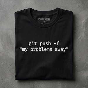 May include: A black short-sleeved t-shirt featuring white text that reads git push -f "my problems away". The shirt has a crew neckline and a PixelPrints brand label printed on the inside collar area, indicating a size M for the garment.
