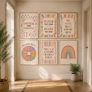 May include: A set of six framed wall art prints featuring pastel-colored designs. The prints include text such as Progress Over Perfection, Hands That Learn Minds That Grow, Try Again That's How We Grow, Feelings Wheel, and This Is A Sensory Friendly Space.