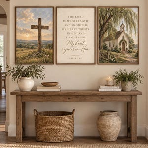 May include: A set of three framed wall art prints featuring a wooden cross in a landscape, a central print with the text 'The Lord is my strength and my shield; my heart trusts in Him, and I am helped. My heart rejoices in Him. Psalm 28:7', and a church.