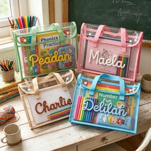 May include: Four rectangular clear plastic storage bags with fabric handles and snap closures. Each bag features a personalized name in raised, textured lettering on the front, containing various books, colored pencils, and small pencil cases.
