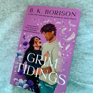 May include: A paperback book titled Grim Tidings by B. K. Borison with a purple cover featuring an illustration of two people embracing, surrounded by white feathers, purple flowers, and sparkles. The text includes the author name and a quote.