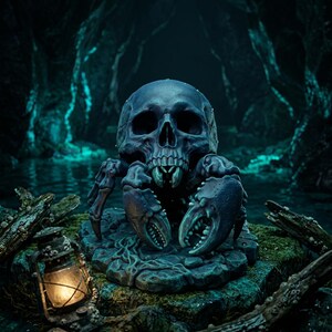 May include: A dark blue, skull-shaped creature with crab-like claws and multiple legs, positioned on a textured base. The figure features a hollow eye socket design and sharp, tooth-like structures near the base of the skull.