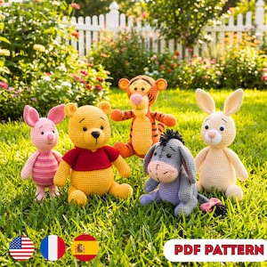 May include: A set of five crocheted stuffed animals including a pink piglet, a yellow bear in a red shirt, an orange tiger with black stripes, a grey donkey, and a cream-coloured rabbit, all arranged together on a patch of green grass.