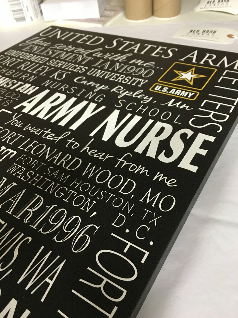 May include: Black wooden sign with white text that reads "UNITED STATES ARMY NURSE" and includes a list of military bases and dates. The sign also features a gold star with the words "U.S. ARMY" underneath.