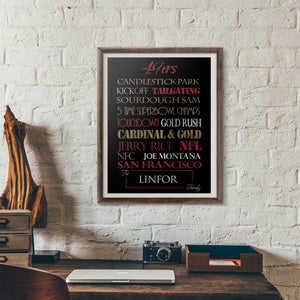 May include: A framed 16x20 print with a black background and gold and red text. The text reads "49ers", "Candlestick Park", "Kickoff Tailgating", "Sourdough Sam", "5 Time Superbowl Champs", "Touchdown Gold Rush", "Cardinal & Gold", "Jerry Rice NFL", "NFC Joe Montana", "San Francisco", "The Linfor Family".