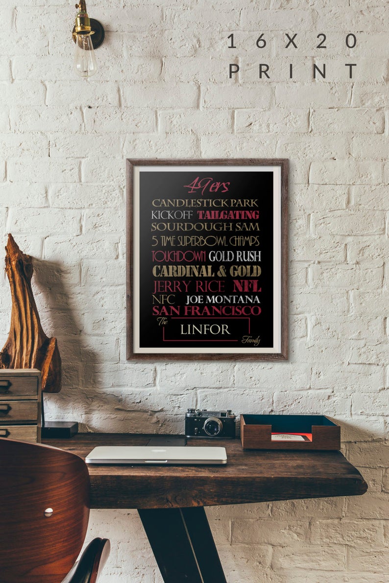 May include: A framed 16x20 print with a black background and gold and red text. The text reads "49ers", "Candlestick Park", "Kickoff Tailgating", "Sourdough Sam", "5 Time Superbowl Champs", "Touchdown Gold Rush", "Cardinal & Gold", "Jerry Rice NFL", "NFC Joe Montana", "San Francisco", "The Linfor Family".