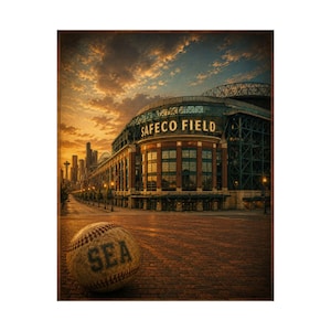 May include: A baseball with the letters SEA printed on it sits on a brick surface in front of Safeco Field. The stadium features large windows and a metal structure under a sunset sky with clouds. The Seattle skyline is visible in the distance.