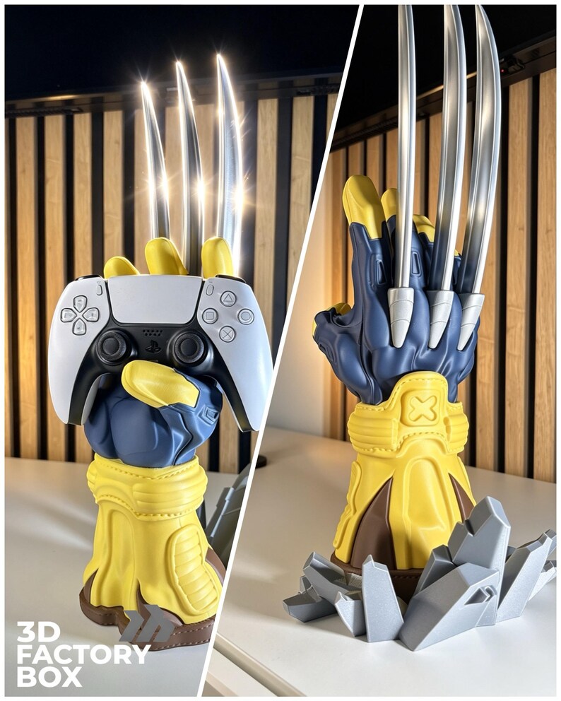 May include: A blue and yellow sculpted hand stand featuring three long silver metallic claws extending upward. The hand is designed to hold a white and black game controller. The base is decorated with gray jagged rock-like elements.