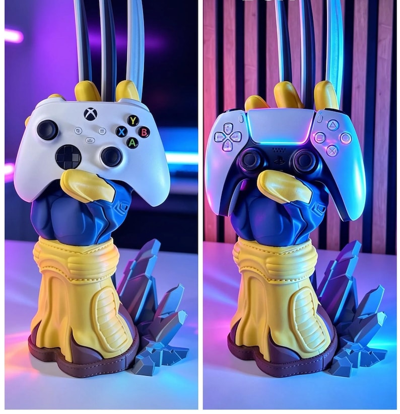 May include: A blue and yellow sculpted hand stand featuring three metallic claws extending upward, designed to hold a white Xbox controller or a white and black PlayStation controller. The base is shaped like jagged rock formations.