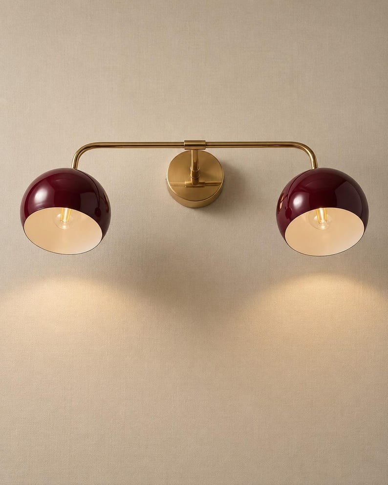burgundy wall sconce
double wall sconce
brass vanity light
modern wall fixture
dual arm wall light
bathroom wall light
mid century light
burgundy sconce
vanity light brass
minimalist light
wall light fixture
home decor light
luxury wall light
burgundy wall sconce, double wall light, brass wall sconce, vanity wall light, modern wall lamp, bathroom lighting, dome shade light, 2 light sconce, minimal wall light, bedside wall lamp, contemporary light, wall sconce brass, vanity light fixture