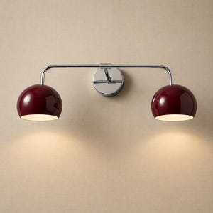 burgundy wall sconce
double wall sconce
brass vanity light
modern wall fixture
dual arm wall light
bathroom wall light
mid century light
burgundy sconce
vanity light brass
minimalist light
wall light fixture
home decor light
luxury wall light
burgundy wall sconce, double wall light, brass wall sconce, vanity wall light, modern wall lamp, bathroom lighting, dome shade light, 2 light sconce, minimal wall light, bedside wall lamp, contemporary light, wall sconce brass, vanity light fixture
