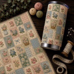 May include: A cylindrical tumbler and a rectangular fabric piece both featuring a patchwork pattern of floral bouquets, bows, and gingham squares in shades of pink, blue, and green. The tumbler has a silver base and a clear lid.