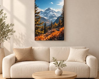 May include: A vertical wall art print featuring a snow-capped mountain peak under a clear blue sky, framed by evergreen trees and vibrant orange autumn foliage in the foreground. The artwork is displayed above a cream-coloured sofa and coffee table.