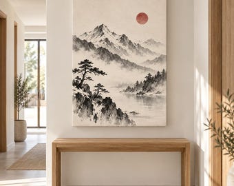 May include: A vertical wall art print featuring a monochromatic landscape of snow-capped mountains, pine trees, and a calm lake. A single, solid red circle representing the sun is positioned in the upper right sky against a cream background.
