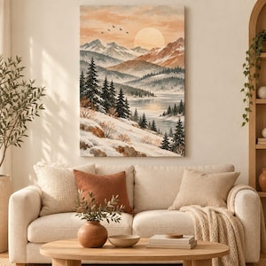 May include: A vertical wall art print depicting a winter mountain landscape with snow-covered slopes, evergreen trees, a calm lake, and a large sun in a soft peach-toned sky. Several birds are flying in the distance above the peaks.