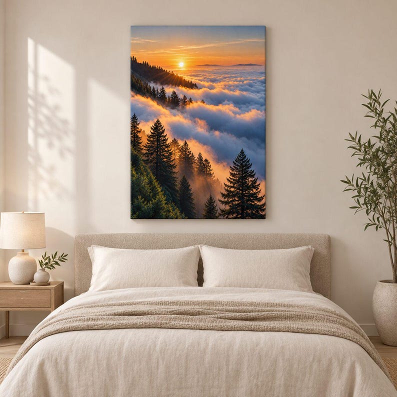 May include: A vertical rectangular wall art print featuring a sunrise over a dense forest of evergreen trees partially obscured by a thick layer of clouds. The sky displays warm orange and yellow hues, casting a golden glow on the misty landscape.