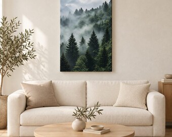 May include: A rectangular wall art print featuring a dense forest of dark green pine trees shrouded in thick, low-hanging white mist and fog. The scene captures a mountainous landscape with layers of evergreen trees fading into the cloudy sky.