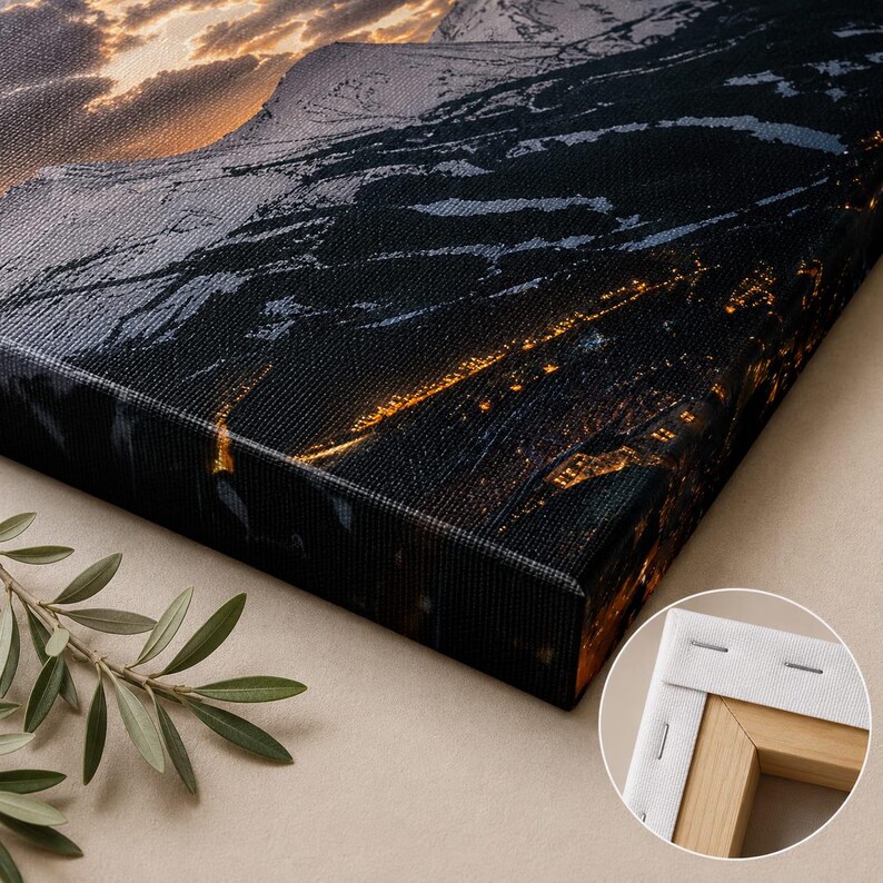 May include: A rectangular canvas print featuring a dark mountain landscape at night with glowing golden city lights and a sunset sky. The canvas is stretched over a wooden frame, shown in a circular inset detail revealing the back corner construction.