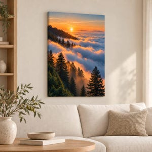 May include: A vertical rectangular canvas wall art print depicting a mountain landscape at sunset. The scene features dark green pine trees silhouetted against a bright orange sky, with a thick layer of clouds filling the valley below the sun.