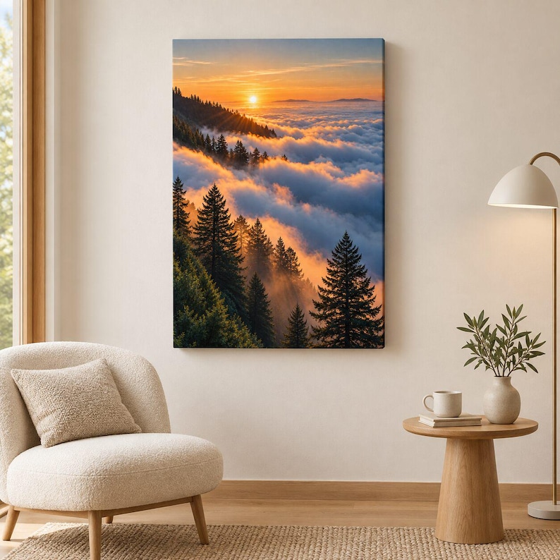 May include: A rectangular wall art print featuring a landscape of evergreen trees on a mountainside during sunset. The scene shows a bright orange sun glowing above a thick layer of clouds that blankets the valley below the dark green forest.