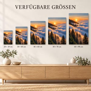 May include: Five rectangular wall art prints featuring a sunset over a forest and clouds, arranged by size from 20x30 cm to 60x90 cm. The text VERF&Uuml;GBARE GR&Ouml;SSEN appears above the prints, with specific metric dimensions listed below each individual piece.