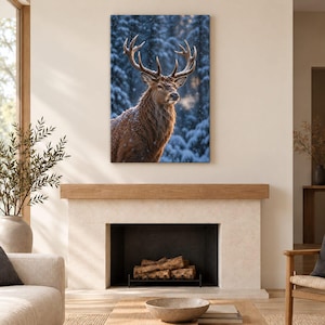May include: A rectangular wall art print featuring a brown stag with large antlers standing in a snowy forest. The deer is captured in profile, with visible breath vapor and light snowfall against a backdrop of dark, snow-covered pine trees.