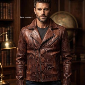 May include: A brown leather motorcycle jacket with a textured snakeskin pattern, featuring a wide notched collar, an asymmetrical front zip closure, a small flap pocket with a snap button, and additional zipped pockets on the chest and sides.