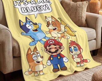 May include: A soft yellow fleece throw blanket featuring a cartoon graphic of Bluey, Bingo, and Mario. A speech bubble at the top contains the text IT'S-A ME, BLUEY! The characters are depicted in various poses, with Mario appearing distressed while the other characters smile and hold a banana.