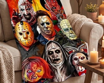 May include: A rectangular fleece throw blanket featuring a vibrant, multi-coloured graphic print of various horror movie characters, including a clown, a hockey mask, a nun, and a doll, arranged in a collage against a fiery orange background.