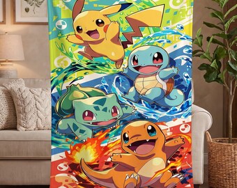 May include: A rectangular throw blanket featuring a vibrant graphic print of four characters: a yellow Pikachu, a blue Squirtle, a green Bulbasaur, and an orange Charmander. The design includes dynamic water and fire elements with geometric shapes.