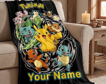 May include: A black fleece blanket featuring the yellow Pokémon logo at the top and various colorful Pokémon characters including Pikachu, Bulbasaur, Charmander, and Squirtle in the center, with the yellow text Your Name printed at the bottom.