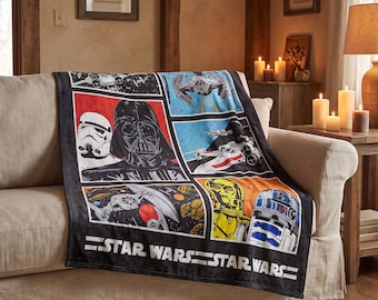 May include: A black fleece throw blanket featuring a multi-panel graphic print of Star Wars characters and starships, including Darth Vader, a Stormtrooper, C-3PO, and R2-D2. The bottom of the blanket displays the white Star Wars logo text.