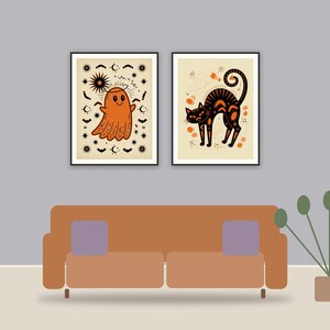 halloween decor printable art framed above a sofa in a styled living room