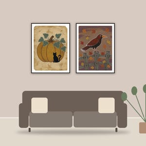farmhouse halloween printable art framed above a sofa in a styled living room