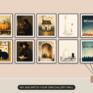 Ten Halloween prints from the bundle framed together as a gallery wall above a console table