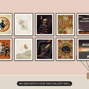 Ten Halloween prints from the bundle framed together as a spooky gallery wall above a console table