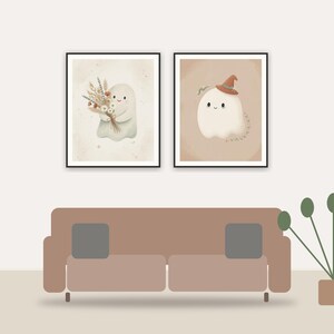 Cute boho ghost printable art framed above a sofa in a styled living room