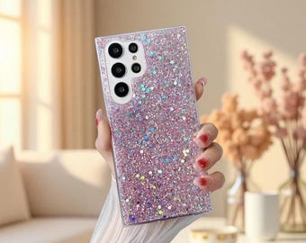 May include: A rectangular smartphone case featuring a dense, sparkling pink glitter finish with scattered iridescent flecks. The case includes a precise cutout for a multi-lens camera system, showcasing four circular lenses and a flash sensor.