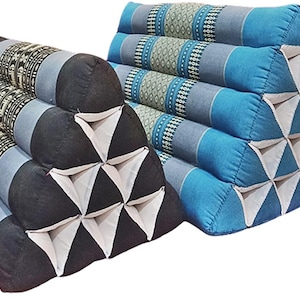 May include: Two triangular-shaped cushions featuring a geometric pattern. One cushion is primarily black with white triangular accents, while the other is blue with white triangular accents. Both feature bands of grey and patterned fabric.