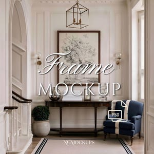 May include: A rectangular wall frame mockup featuring a black and white floral sketch, centered above a dark wood console table. The scene includes a navy blue armchair, a potted topiary, a geometric pendant light, and wall sconces in a hallway.