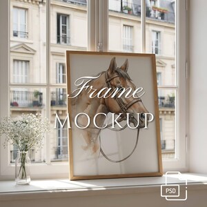 May include: A light wood frame containing a watercolor illustration of a brown horse head wearing a bridle. The text "Frame MOCKUP" is overlaid in white script and sans-serif font. A small white PSD icon is in the bottom right corner.