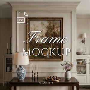 May include: A rectangular gold-toned picture frame containing a landscape painting of trees and a path, mounted on a beige paneled wall. The text "Frame MOCKUP" is centered over the artwork, with a small "PSD" icon in the upper left corner.