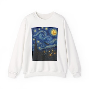 May include: A white long-sleeve sweatshirt featuring a large rectangular graphic print on the front. The print depicts a dark blue night sky with swirling patterns, a bright yellow crescent moon, glowing stars, and a dark silhouette of a tree.