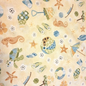 May include: A light yellow fabric with a repeating pattern of beach-themed illustrations. The design includes starfish, seashells, seahorses, beach balls, flip-flops, and beach umbrellas in shades of blue, green, and orange.