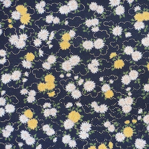 May include: Navy blue fabric with a floral pattern. It features clusters of white and yellow flowers with green leaves, linked by dotted gold lines. The design creates a dense, decorative floral print, suitable for various craft projects.