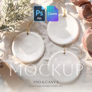 May include: Three smooth, circular white ceramic ornaments with gold hanging strings. The ornaments are blank and feature a glossy finish. The image includes text overlays reading Ps PSD and Canva, along with the word MOCKUP PSD & CANVA.