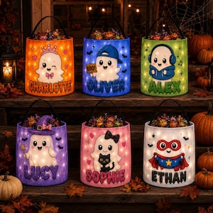 May include: Six cylindrical Halloween candy buckets with black handles, each featuring a unique ghost character and a personalised name: Charlotte, Oliver, Alex, Lucy, Sophie, and Ethan. The buckets are illuminated with small LED lights.