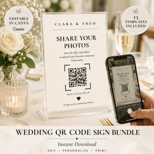May include: A vertical acrylic sign holder displaying a cream-colored card with black text reading CLARA & THEO, SHARE YOUR PHOTOS, and instructions to scan the QR code below to upload memories, finished with a small heart icon at the bottom.